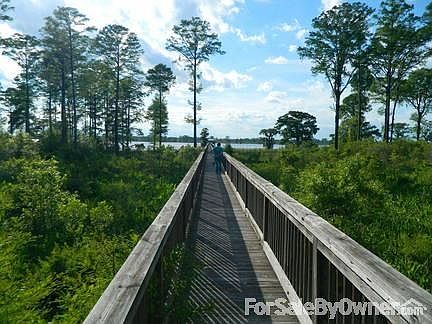 Dock Entrance : View down 900 foot dock, two dock houses, and boat lifts to river.
