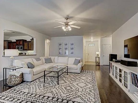 Living Room open to kitchen and dining room. Dimensions: 18' x 23' *Furniture for staging purposes only