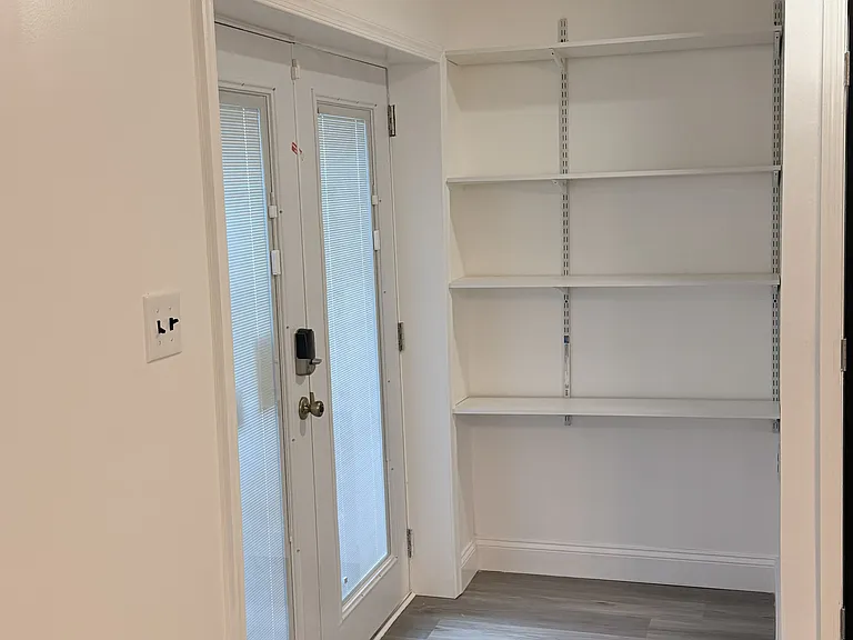 Foyer with shelves for storage.