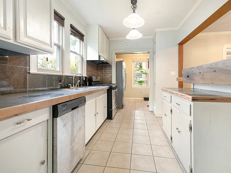 Kitchen with gas range and prep island.