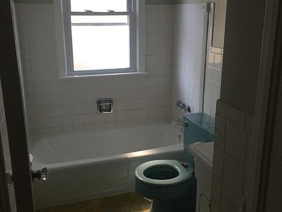 Blue toilet being replaced when new flooring gets installed
