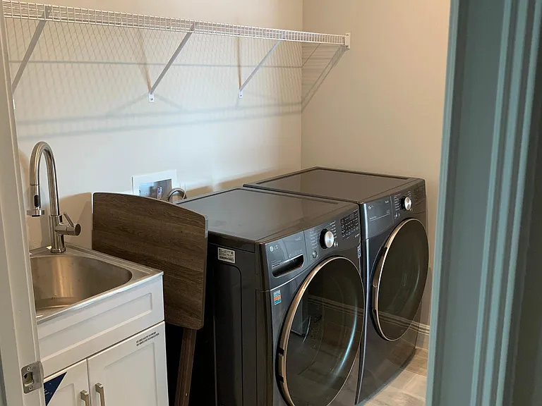 Laundry room with access door to the garage and kitchen