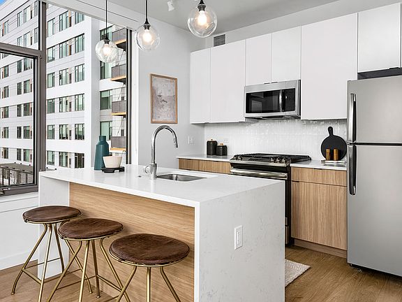 Sleek cabinetry, quartz countertops, and modern lighting make this Eleven33 kitchen the perfect mix of form and function refined, bright, and built for everyday living.
