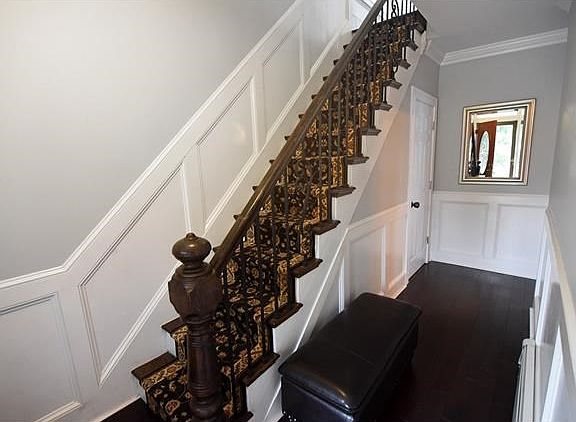 Elegant entry hall with wainscoting & crown-molding