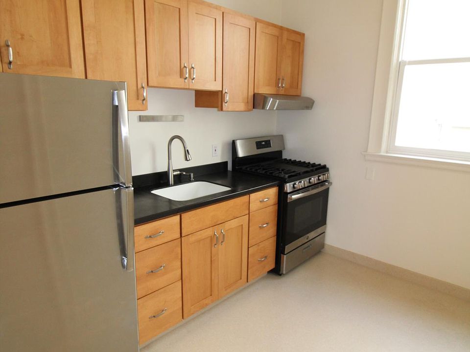 Kitchen with corian countertops and flooring.