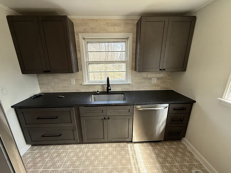 Newly remodeled kitchen with granite countertops, stainless steel appliances and tiled backsplash