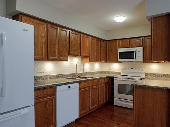 Family sized French door refrigerator with bottom freezer drawer. Ceramic tile backsplash for easy cleaning throughout the kitchen area.