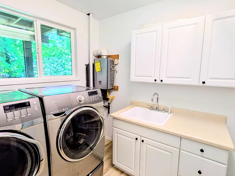 Full laundry room and newer tankless water heater
