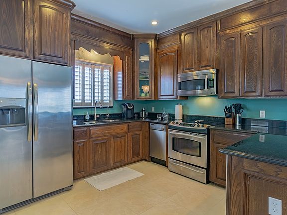 Kitchen is stocked with everything you'd need. The blue is now painted white.