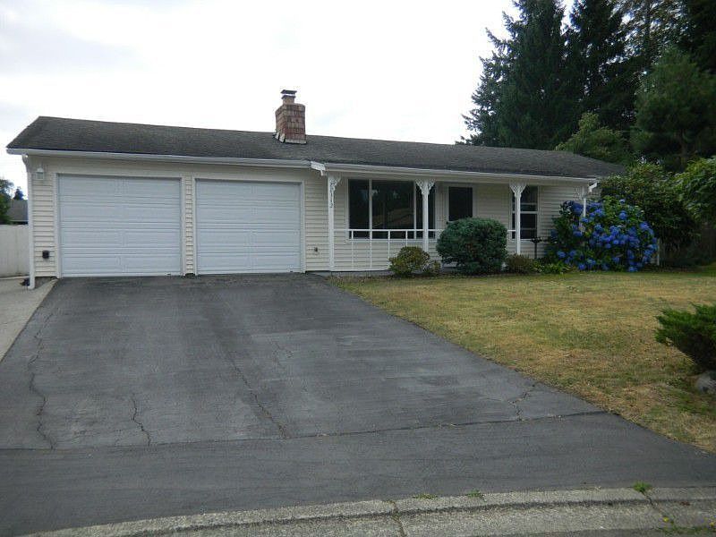 Looking up at the house from bottom of driveway. Located in the middle of a cul de sac