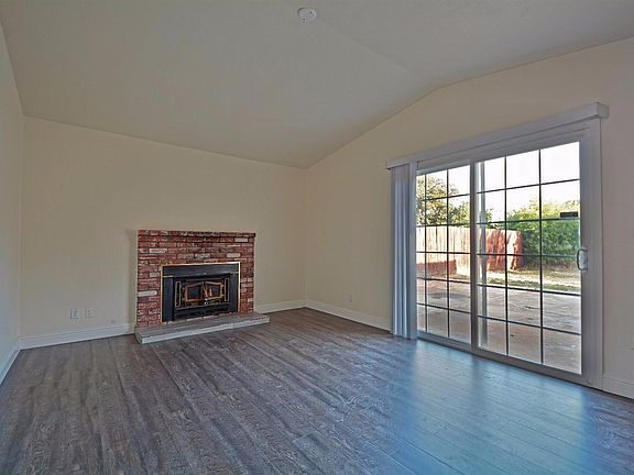Family room with new beautiful laminate floors, paint, and baseboards