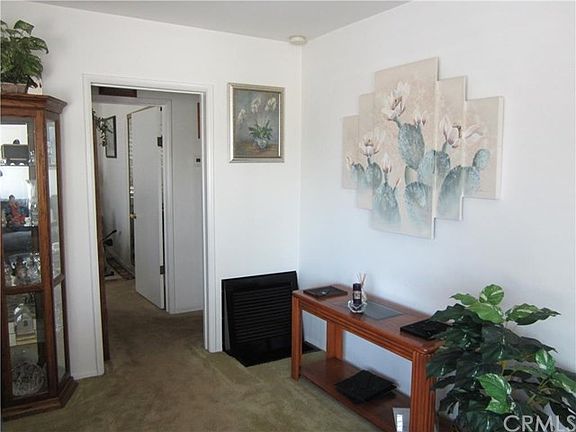View of the living room leading to hallway and bedroom #1