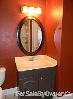 cultured marble in hall bath
						:
						Dark red accents and yellow in kitchen further the Tuscany style