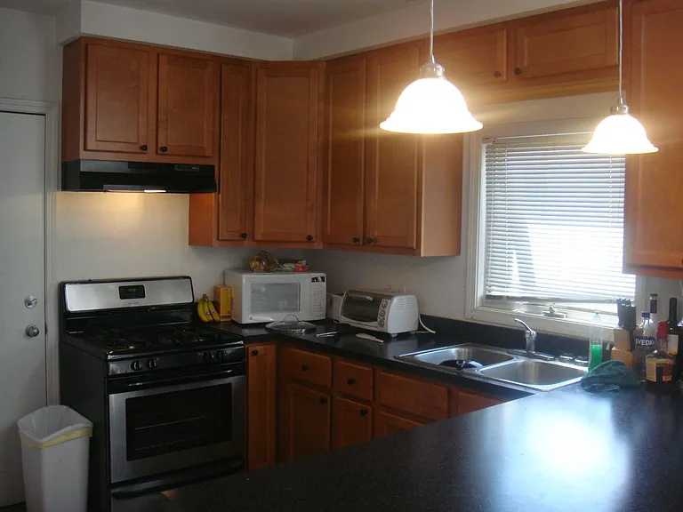 KICHEN WITH MAPLE CABINETS AND ALL STAINLESS STEEL APPLIANCES - DISHWASHER, STOVE AND FRIDGE