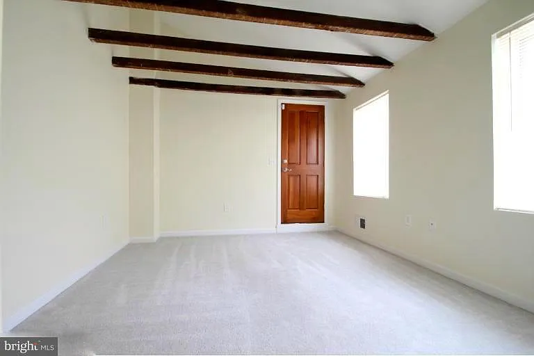 2nd Floor: Medium Sized bedroom viewing toward back of house with doorway to rooftop deck.