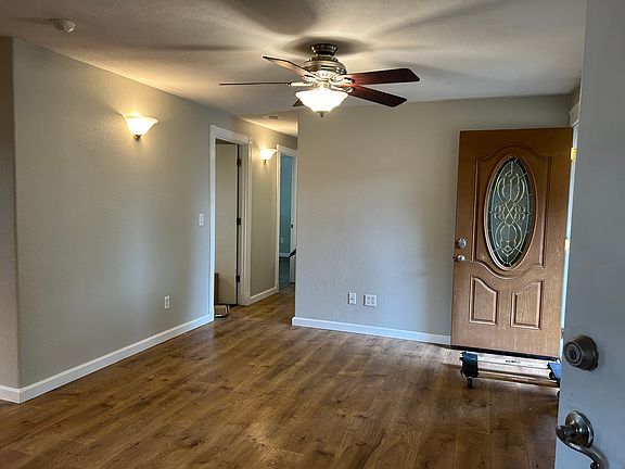 Opened front door, Living Room and start of Hallway to Bedrooms