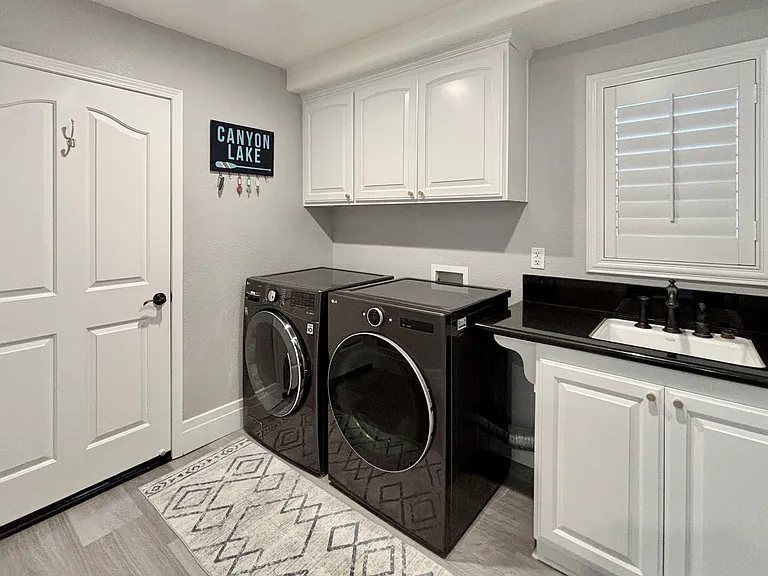 Laundry room with full size appliances and utility sink