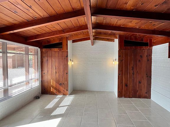 Living area - high beam ceiling with low voltage LED light strip, lighted alcove width of queen bed+, closets either side with overhead "cubbies" for storage. Freshly tiled floors.