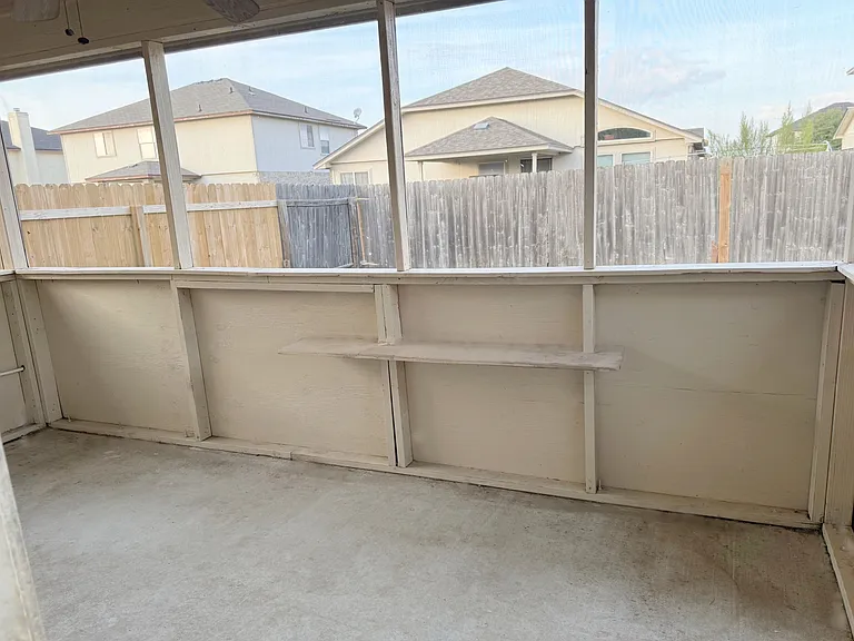 Fenced backyard with a screened patio. Also includes a shed in backyard.