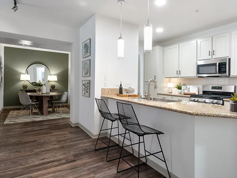 Kitchens include luxury vinyl plank flooring, gas ranges, and stainless steel appliances