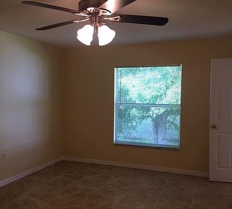 Master bedroom with large tree shading window