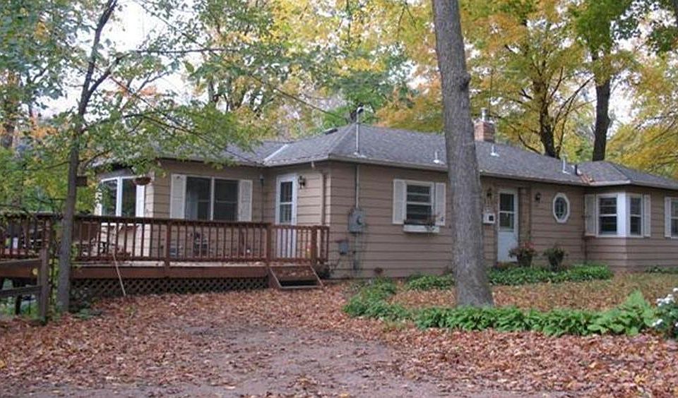 Front of house showing deck. Many hostas. Parking on upper level