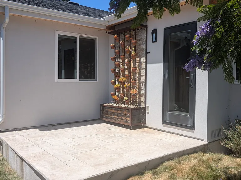 Front patio, is large enough for a table and seating. The succulent wall is a waterfall as well to provide a serene ambiance.
