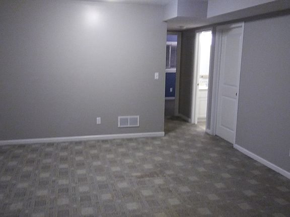 Downstairs living room looking towards hall to bath and 2 be