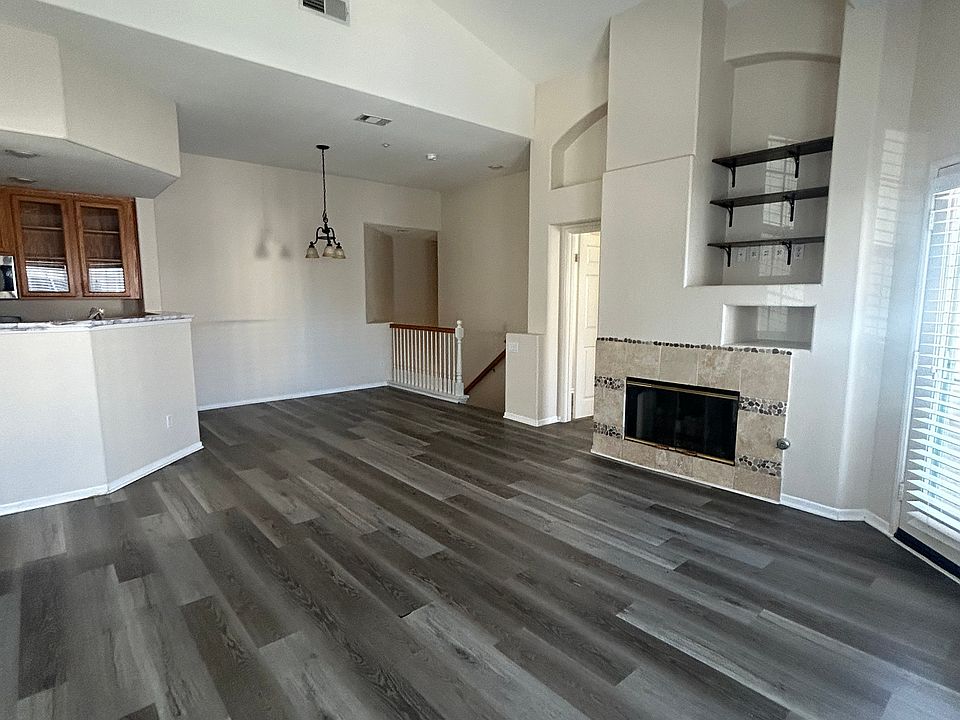 Living room area with fireplace 
and open kitchen design