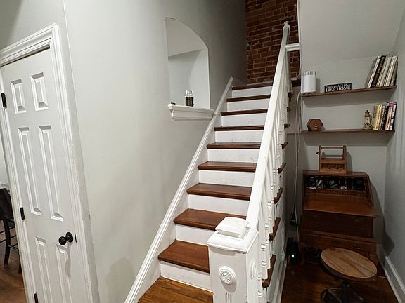 Living Room, stairs and coat closet.