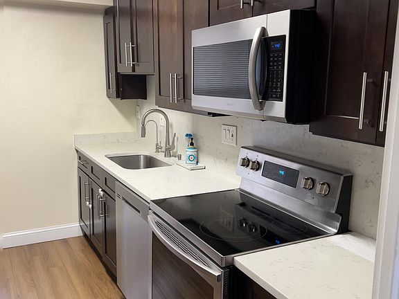 Brand New Kitchen with New Appliances, Quartz Counter Top and Matching Quartz Backsplash.