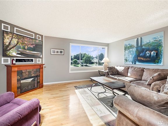 Bright living room has electric fireplace