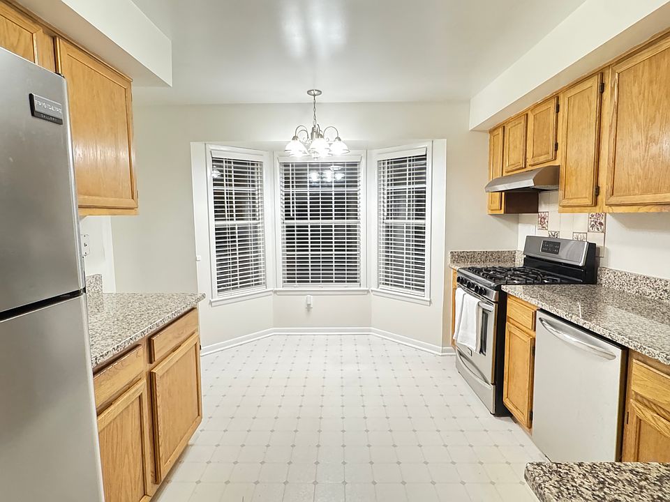 Large eat-in kitchen boasts bay window nook, granite countertops and upgraded stainless steel appliances