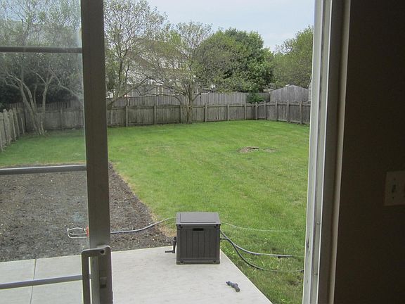 Looking out the sliding back door into the big yard