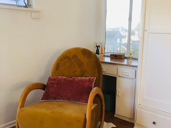 Main bedroom with built in desk. I love this rocker. Sit here in the morning, while reading with a view to the Hollywood sign. Nothing better!