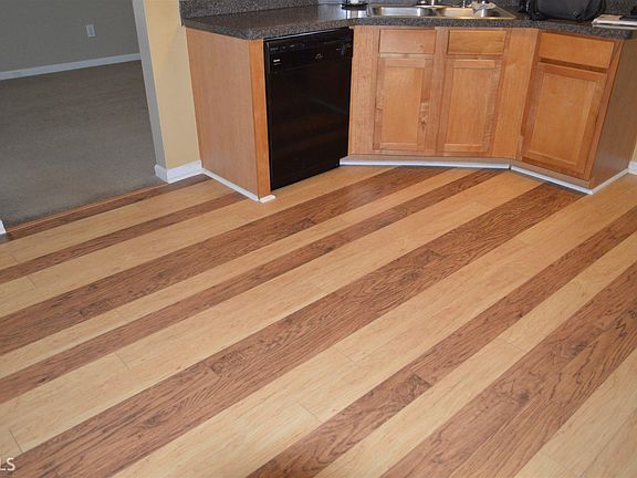 Kitchen with custom Pergo flooring. Black appliance picture