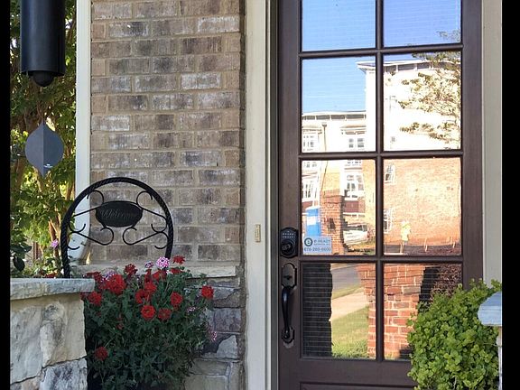 Welcoming entrance from street, neighborhood has sidewalks throughout