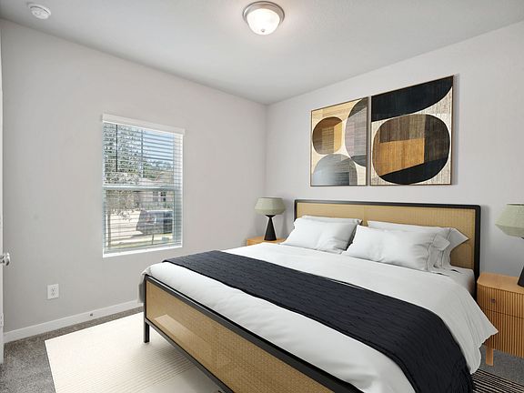 The bedroom in a home in Stewart s Ranch of Conroe, TX.