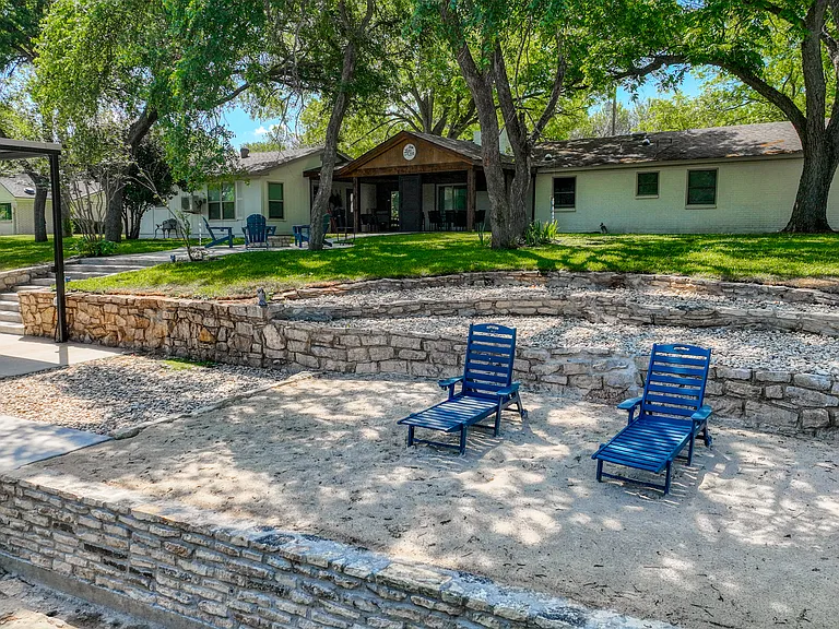Sandy beach area with lounge chairs. Perfect for sand castle building!