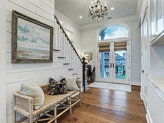 Wide plank engineered hard woods, ship lap detail and a customized beach themed chandelier welcome you into your new home.