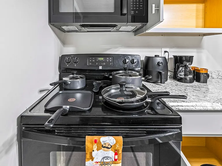Shared kitchen with stove, cookware, and essentials. Save money and cook at home