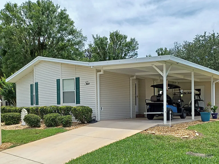 Street View with carport. Locked storage area.