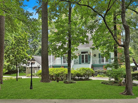 Mature landscaped lot with many shade trees provides a private getaway while still being close to the city