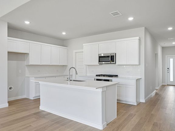 Kitchen in the Masters home plan by Trophy Signature Homes - REPRESENTATIVE PHOTO