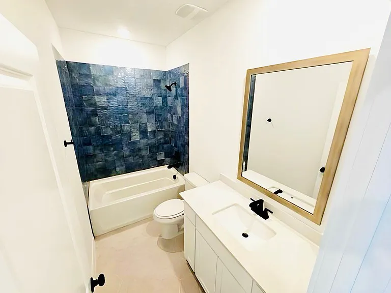 Full bath featuring vanity and washtub / shower combination