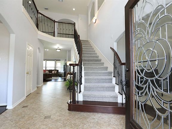Welcome home! The staircase sweeps up to the loft & the foyer opens to the formal dining, sitting room/study, & living room.