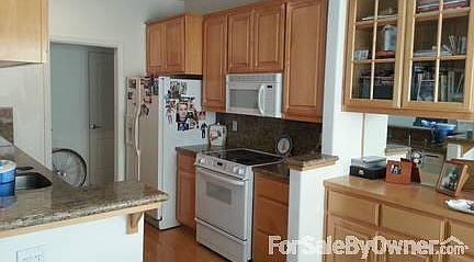 Kitchen from dining room : Other side of kitchen, not pictured, overlooks living room.