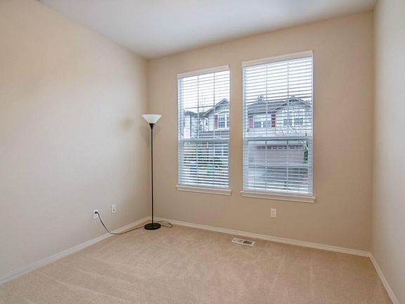 Office room downstairs with two big windows for natural light