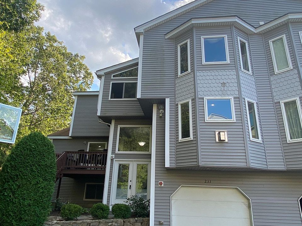 Exterior front, main entry and garage door.