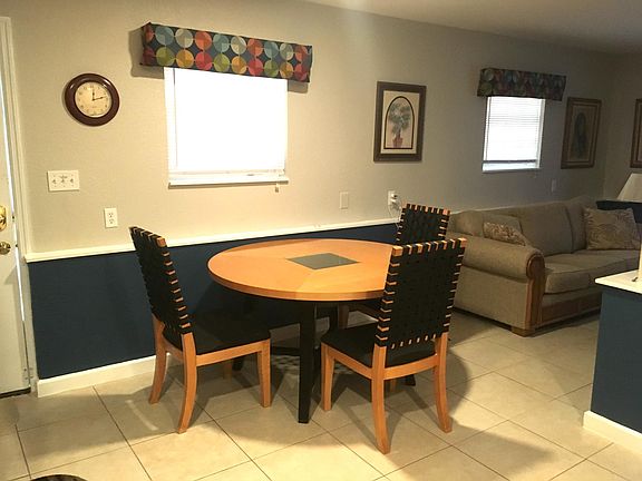 Dining area with large table and 3 chairs